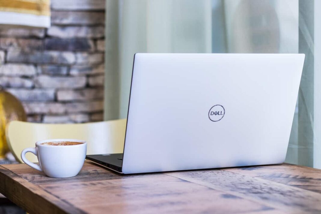 Silver Dell laptop at a cafe