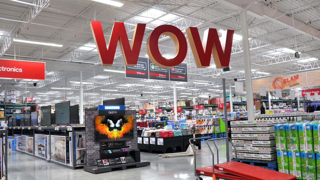 A Big hanging sign made out of red 3D Letters that Reads "WOW"